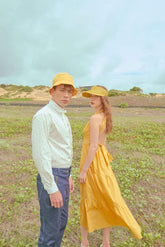 Tiered halter midi dress crafted from flowing silk with open back and adjustable waist tie